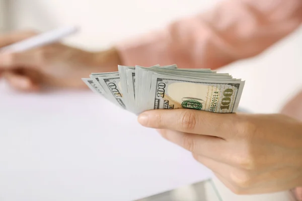 Hand holding dollar banknotes on white background — Stock Photo, Image