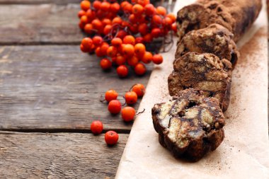 Çikolata salam fırın kağıt üzerinde ahşap arka plan, yakın çekim