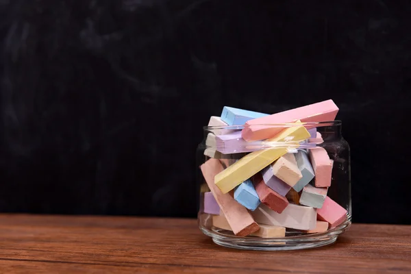 Glass jar with coloured chalk — Stock Photo, Image