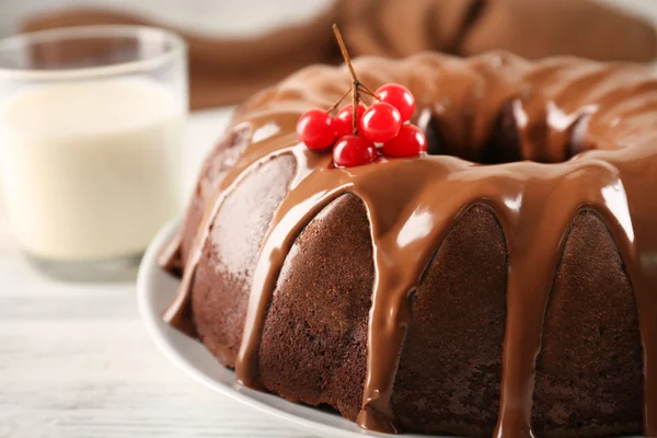 Chocolate cake with a bottle of milk on a table — Stock Photo, Image