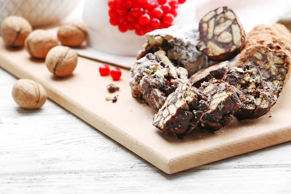 Chocolate salami with walnuts and red berries, close up — Stock Photo, Image