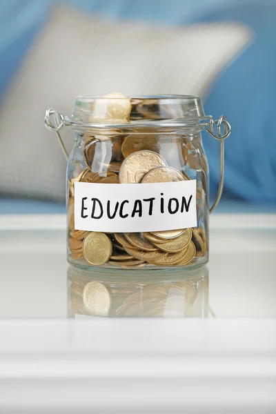 Glass jar with coins for education — Stock Photo, Image