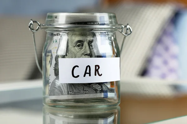 Glass jar with banknotes for car — Stock Photo, Image