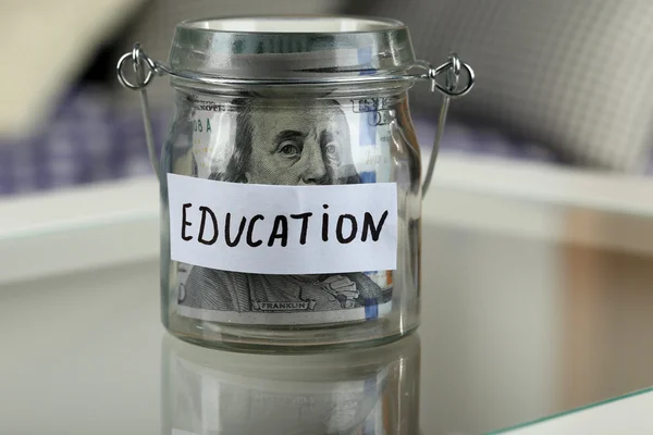 Glass jar with banknotes for education — Stock Photo, Image