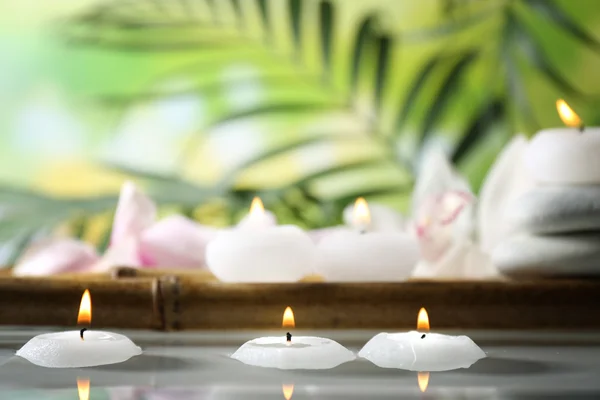 Spa still life with candles in water — Stock Photo, Image