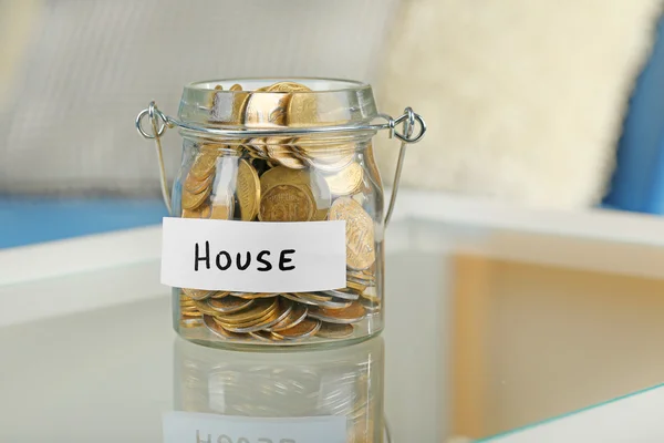 Glass jar with Ukrainian coins — Stock Photo, Image