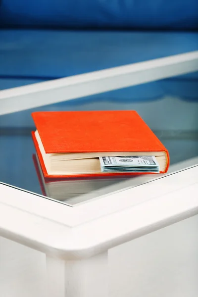 Red book with hidden dollar banknotes — Stock Photo, Image