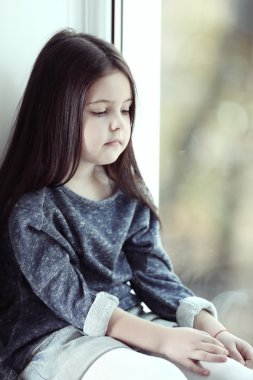 Little girl waiting for someone clipart