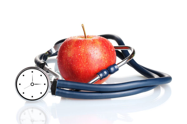 Medical stethoscope with clock and red apple