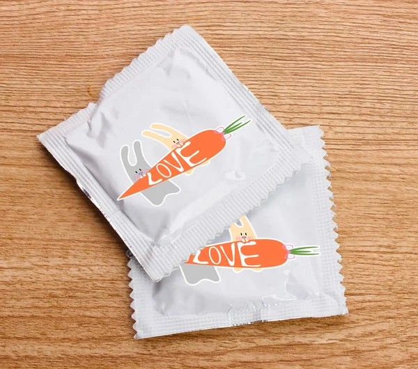 Condoms with pictures on table — Stock Photo, Image