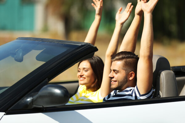 Couple in cabriolet car