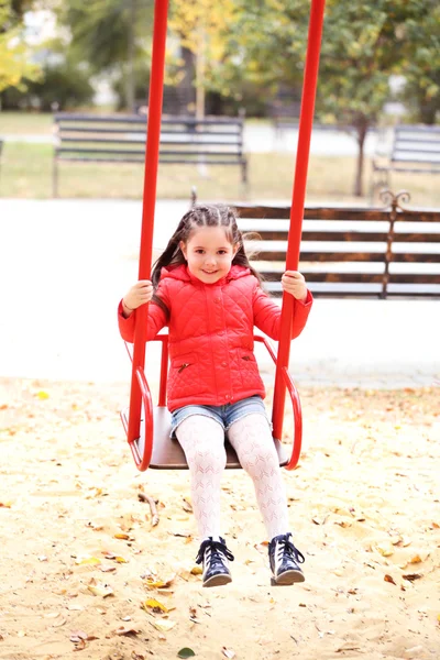 Κοριτσάκι με κούνια στο πάρκο της πόλης — Φωτογραφία Αρχείου