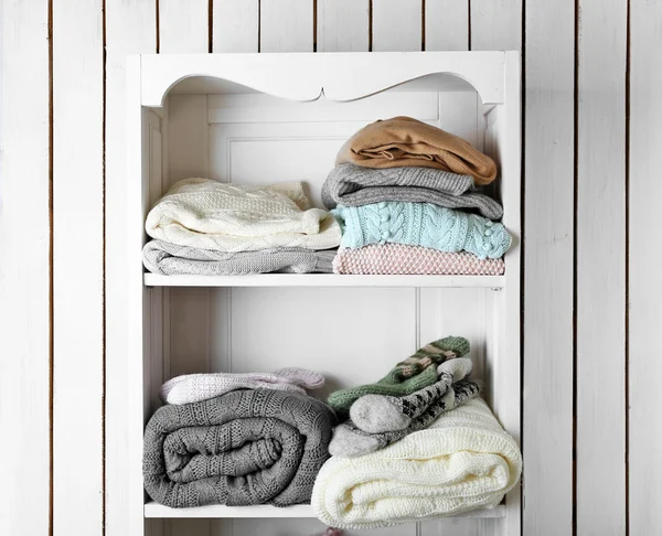Knitting clothes on shelf — Stock Photo, Image