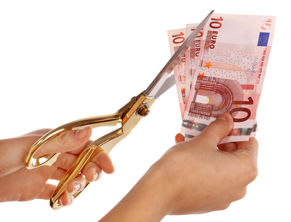 Hands with scissors cutting Euro