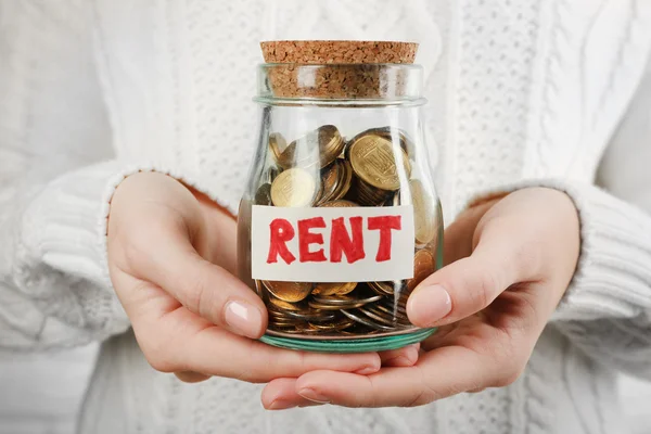 Woman hands with money in glass jar — Stock Photo, Image