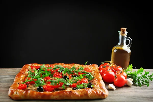 Freshly homemade pizza on black background — Stock Photo, Image