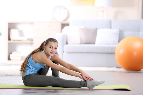 Young girl making fitness exercise indoors — Stock Photo, Image