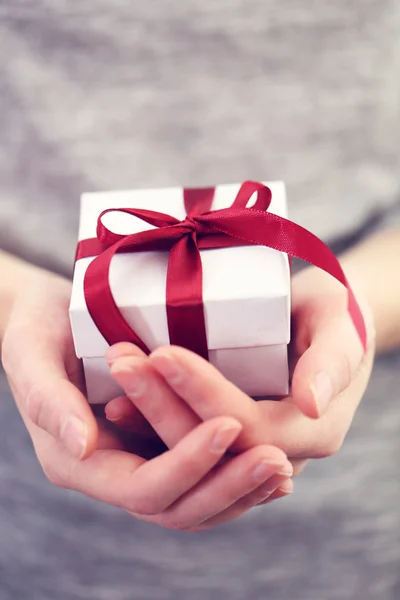 Hands holding beautiful small gift — Stock Photo, Image