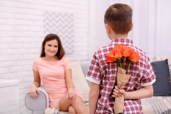 Hijo escondiendo rosas para la madre — Foto de Stock