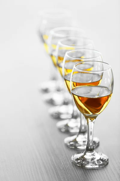 Row of wineglasses on wooden blurred background — Stock Photo, Image