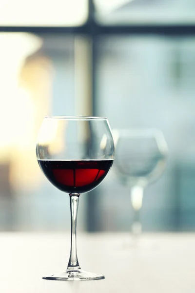Glass of red wine on light blurred background — Stock Photo, Image
