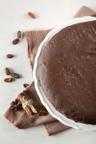 Tasty chocolate frosting cake on light table, close up — Stock Photo, Image