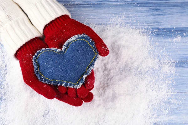 Hands in mittens with decorative heart — Stock Photo, Image