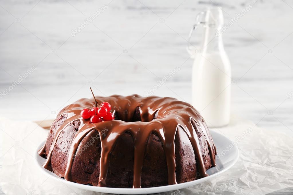 Chocolate cake with a bottle of milk on a table