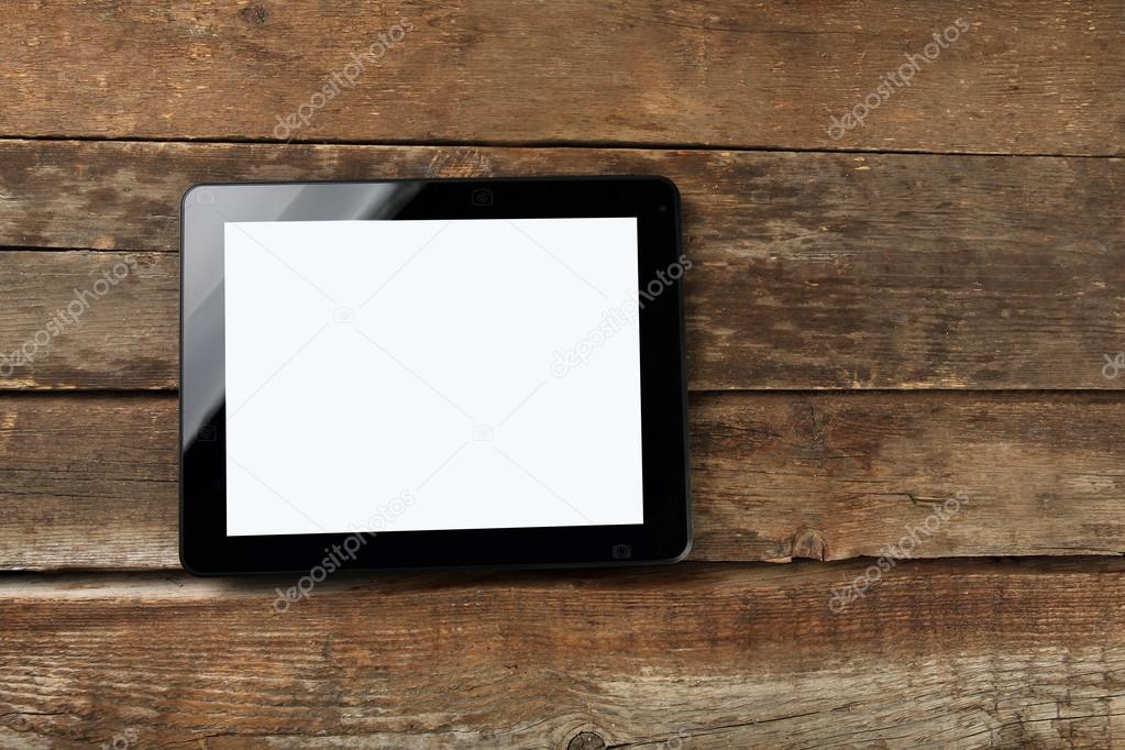 A black modern tablet on the wooden background