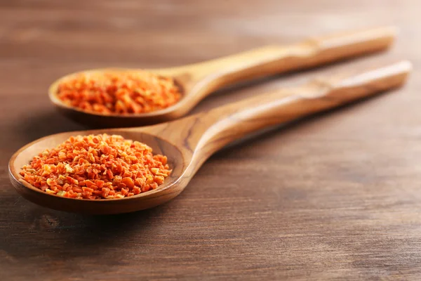 Two wooden spoons with spice on the table, close-up — Stock Photo, Image