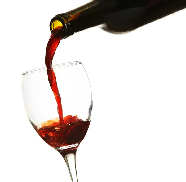 Red wine pouring in glass, isolated on white — Stock Photo, Image