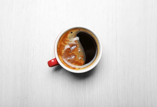 Cup of coffee on light background, top view — Stock Photo, Image