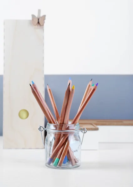 Coloured pencils in a glass pot — Stock Photo, Image