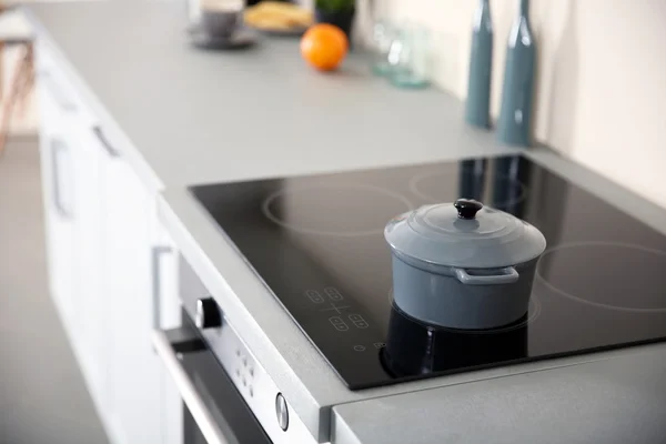 Grey pot on the oven — Stock Photo, Image