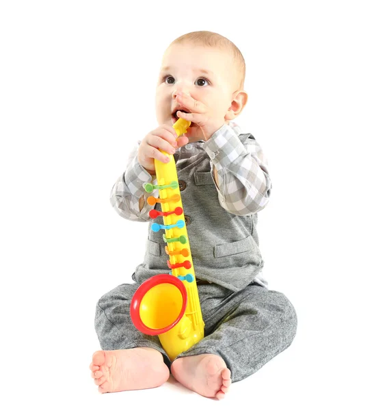 Очаровательный ребенок с пластиковым цветным саксофоном — стоковое фото