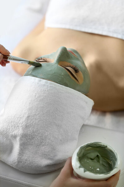 Young woman with nutrient facial mask