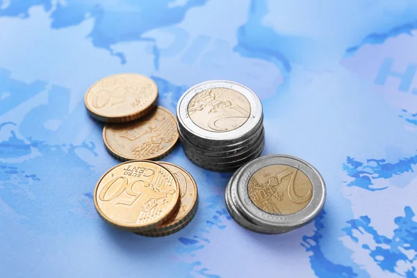 Euro coins on map background — Stock Photo, Image