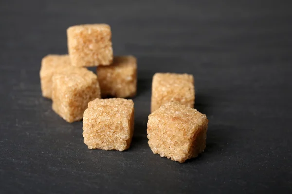 Masanın üzerinde kahverengi şeker küpleri yığını — Stok fotoğraf