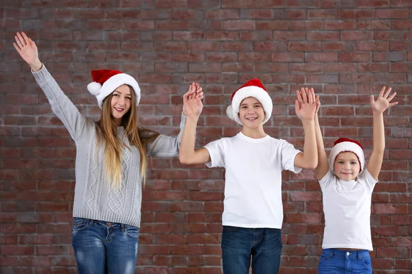 Boys and girl on brick wall — Stock Photo, Image