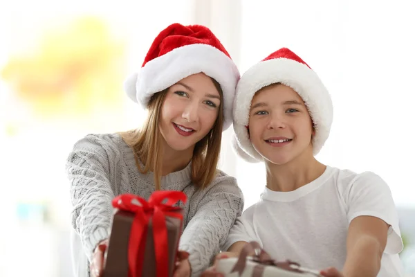 女孩和男孩的肖像在装饰的圣诞房间的礼物 — 图库照片
