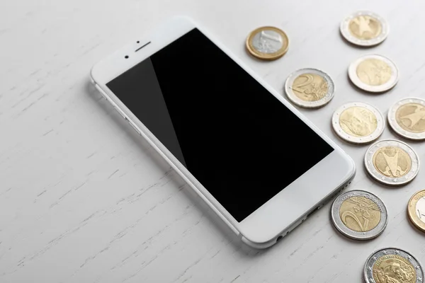 Smart phone and euro coins — Stock Photo, Image