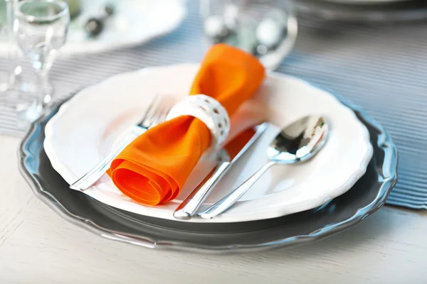 Served table with orange napkin in restaurant, closeup — Stock Photo, Image