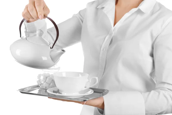 Waiter pouring tea into cup on white background — Stock Photo, Image