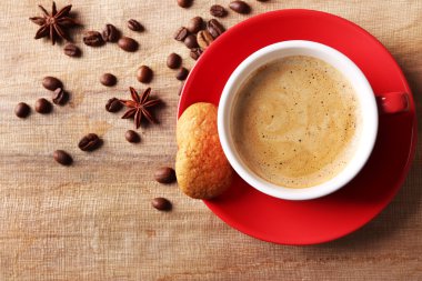 Ahşap masa arkasında bir fincan kahve.