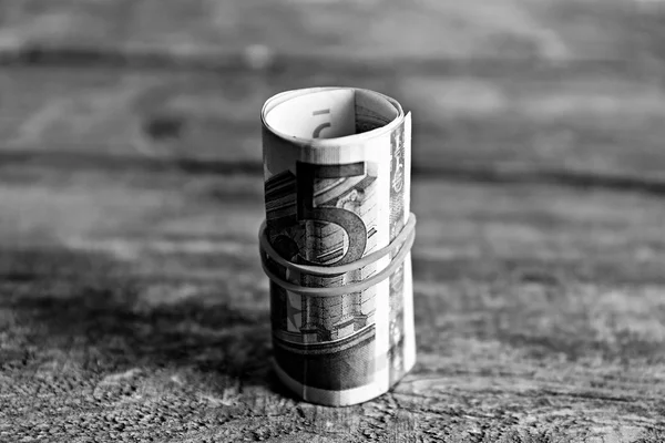 Roll of Euro banknotes on wooden background — Stock Photo, Image