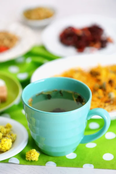 Tasse de thé avec thé sec aromatique sur fond en bois — Photo