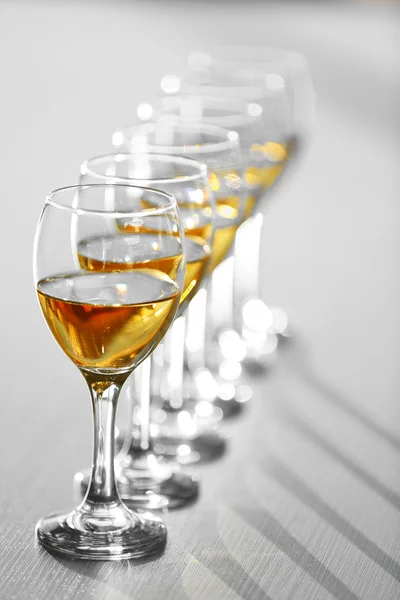 Row of wineglasses on wooden blurred background — Stock Photo, Image