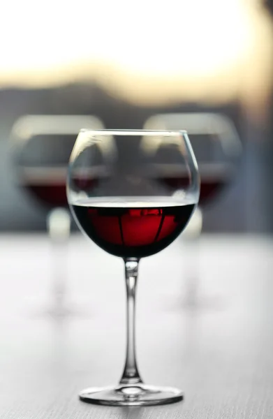 Glass of wine on light blurred background — Stock Photo, Image