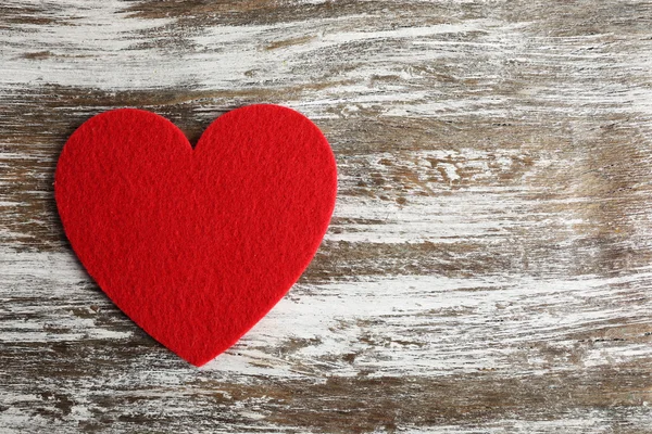 Red felt heart on grey wooden background Stock Photo