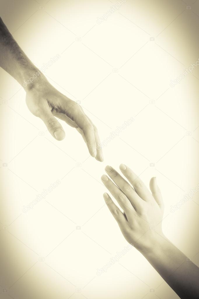 Hands reaching toward each other